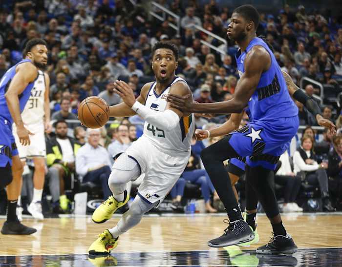 Donovan Mitchell (45) drives past Mo Bamba (5) on his way to the hoop